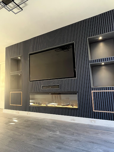 Slatted Media Wall with acoustic panelling and recessed ambient illumination