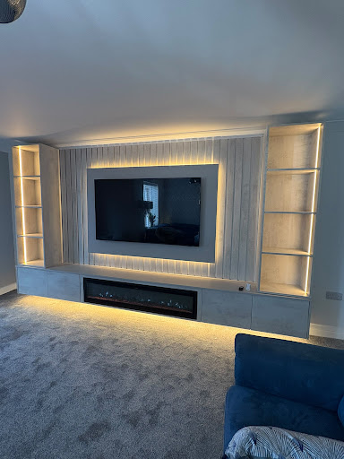 Media Wall with bespoke integrated lowline storage cabinets and floating hearth