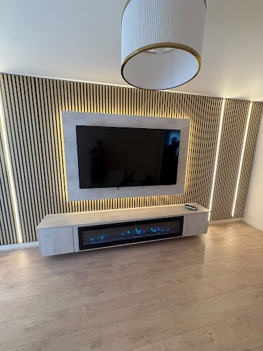 Fireplace Media Wall with concrete hearth and slatted backlit TV wall
