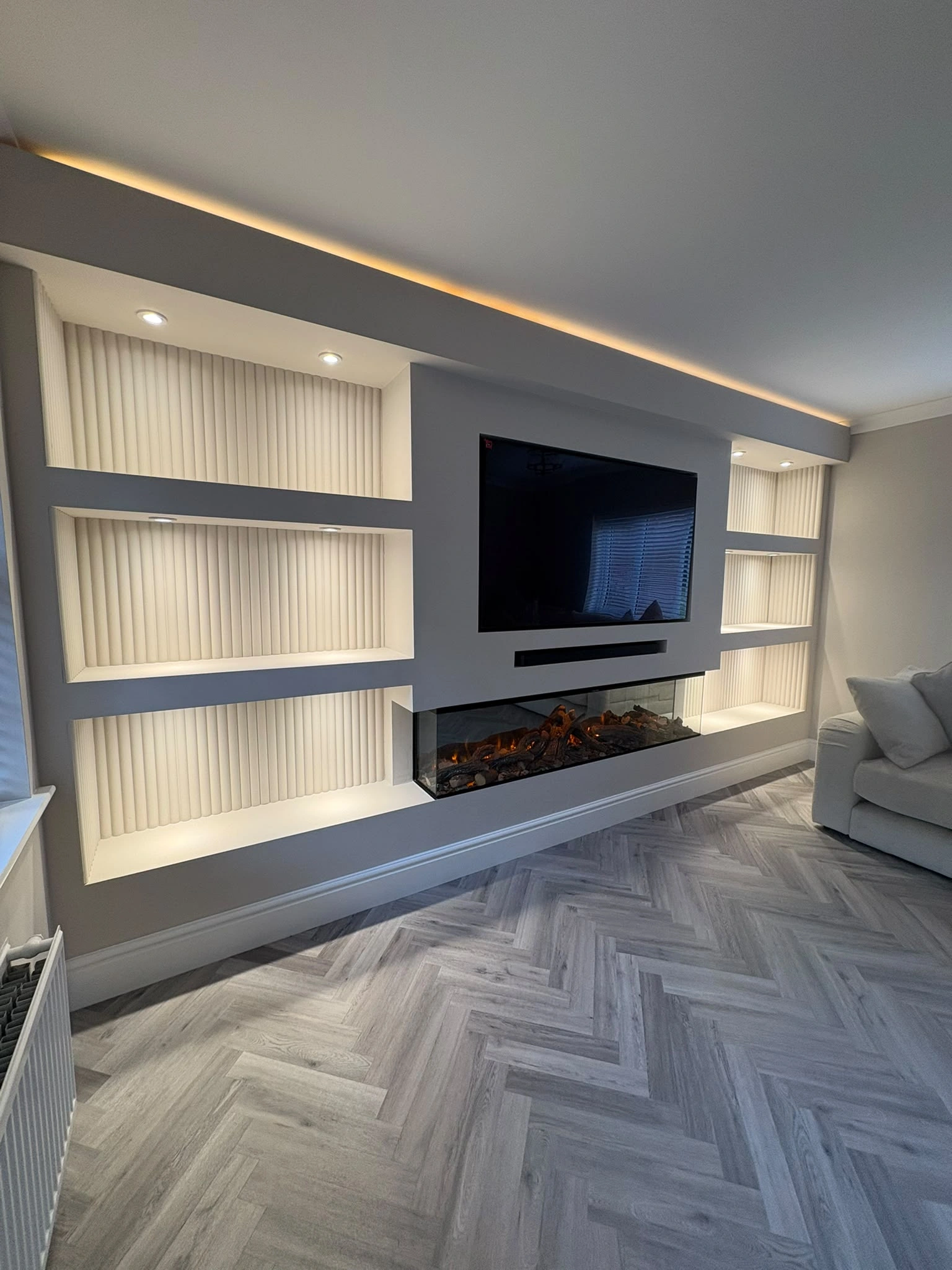 Full-Wall Media Unit with Calacatta marble feature backdrop and ambient lighting